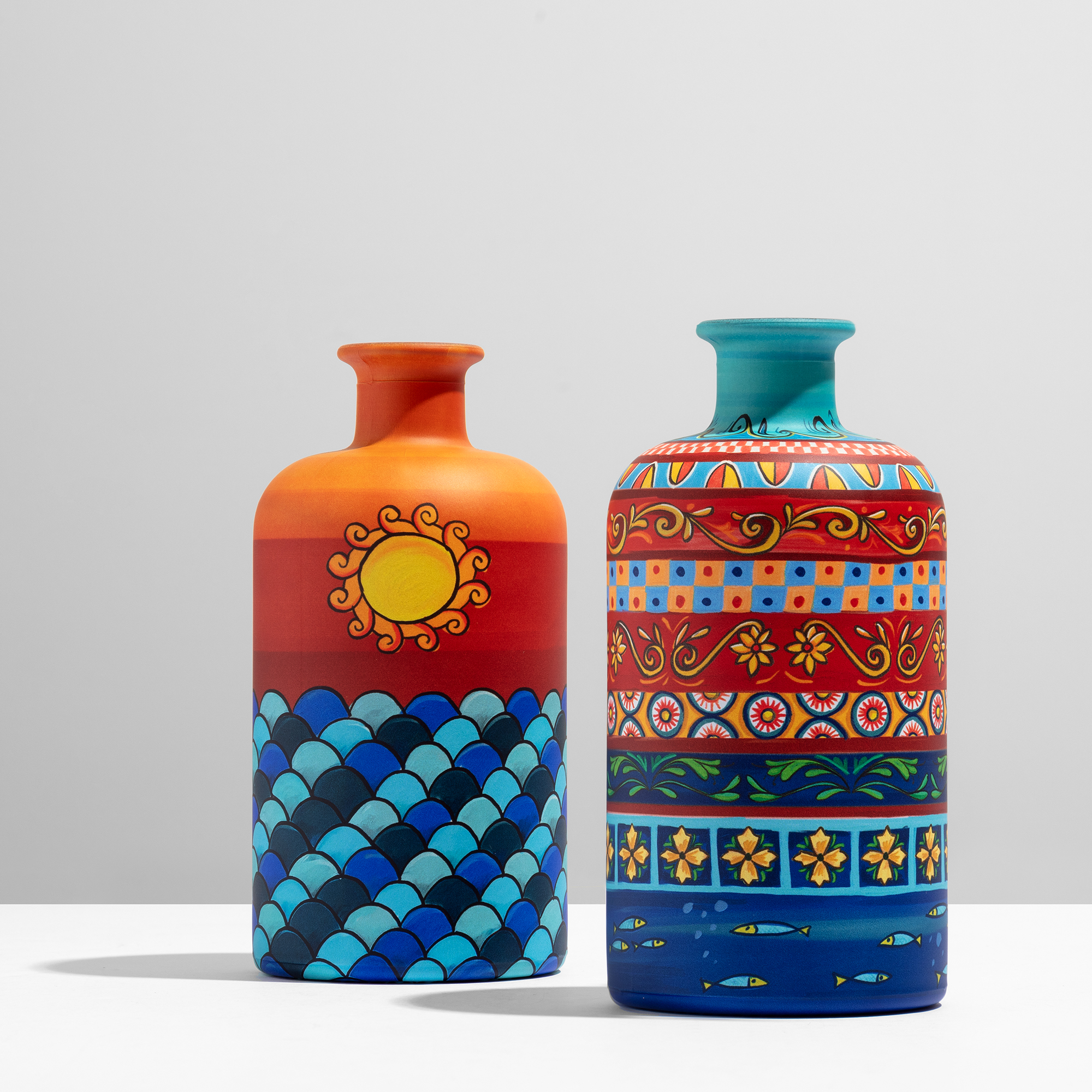 Le Iconiche Romano Vincenzo — two olive oil bottles with sunset and folk art sublimation, Vinitaly Design Awards shortlist