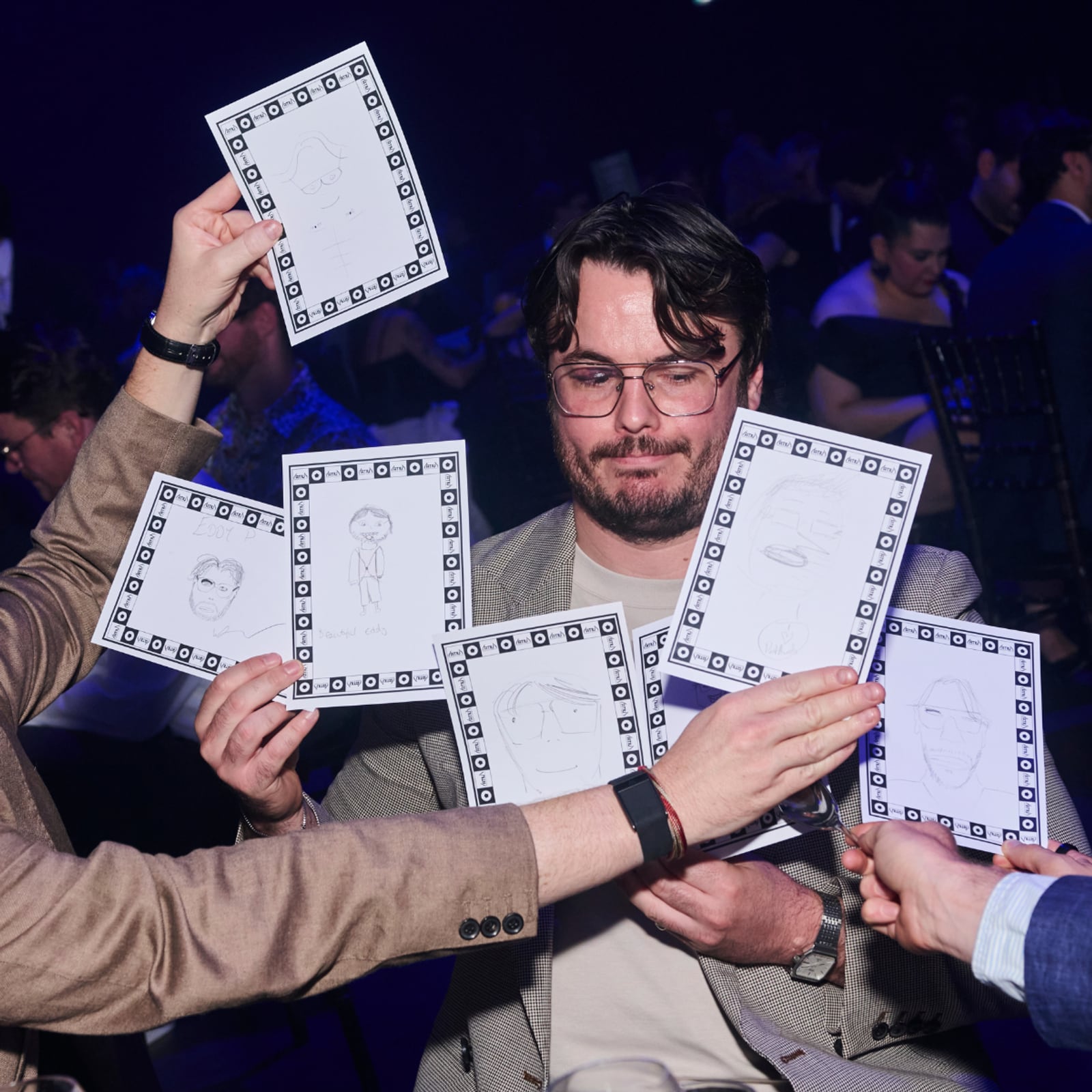 Guests at the Pentawards 2026 gala holding up their Doodle Time portraits on ATIU sheets