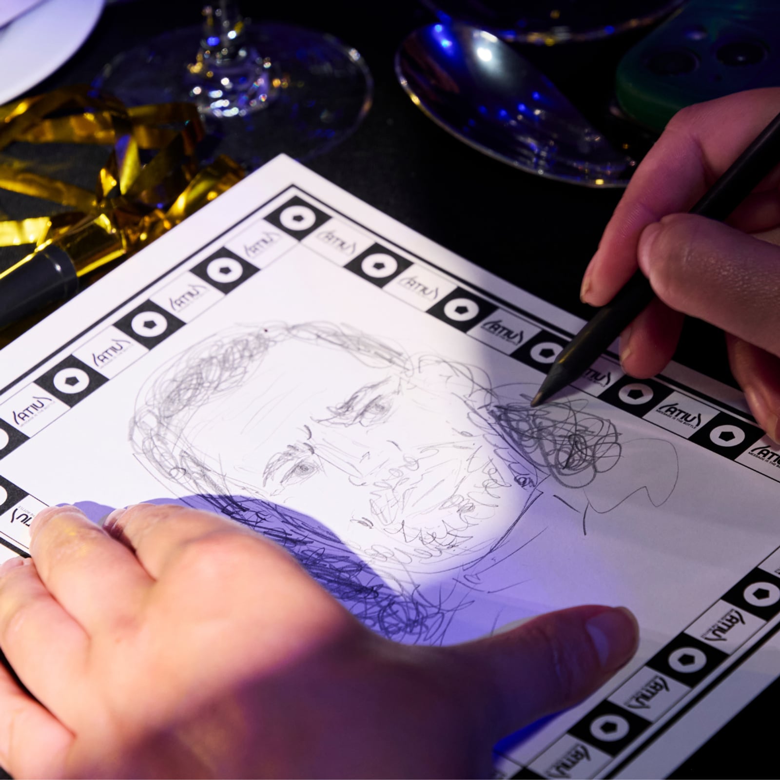 Close-up of a pencil portrait being drawn on an ATIU Doodle Time sheet